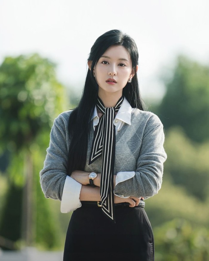 Selain mengenakan jas, Hong Hae In kerap kali tampil santai dengan pemilihan outfit kemeja putih yang dilapisi sweater abu serta dipadukan dengan rok. Citra mewahnya direpresentasikan oleh scarf bergaris memanjang./ Foto: instagram.com/dispatch_style