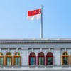 The Flag of Singapore fluttering over the Ministry of Communications and Information. Singapore is a popular tourist destination of Asia.