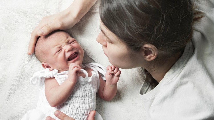 Newborn crying, sleep of children. Tired Mother with Upset Baby Suffering with Post Natal Depression.