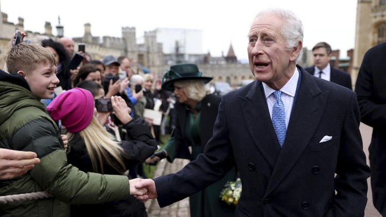 Britain's King Charles III and Queen Camilla greet people after attending the Easter Matins Service at St. George's Chapel, Windsor Castle, England, Sunday, March 31, 2024. (Hollie Adams/Pool Photo via AP)