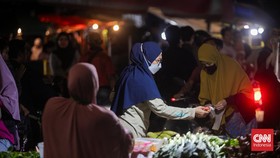 Calon pembeli memilih bahan makanan yang akan dibeli di Pasar Minggu, Jakarta Selatan, Senin (8/4/2024). (CNN Indonesia/Adi Ibrahim)