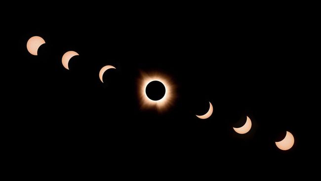 In this composite of seven photographs, the moon passes by the sun during a total solar eclipse in Bloomington, Indiana, on April 8, 2024. This year's path of totality is 115 miles (185 kilometers) wide and home to nearly 32 million Americans, with a
