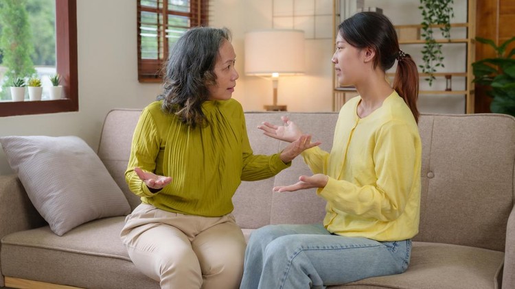 Asian mother and daughter spend their vacation in the living room not talking to each other and angry with each other Both of them showed emotion to each other.