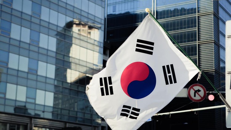 South Korean flag in front of a modern building