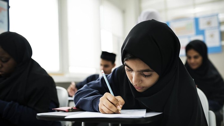 Muslim children studying in classroom