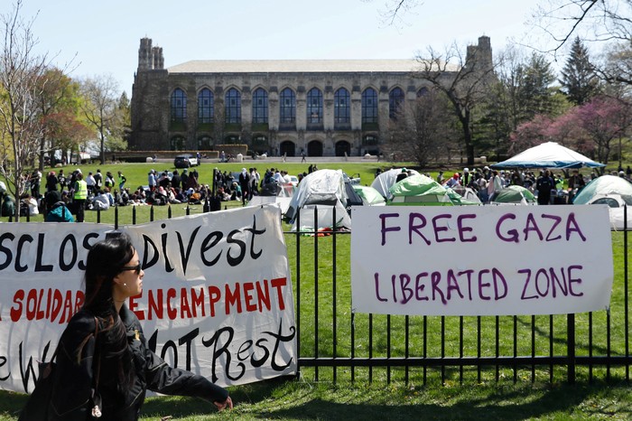 Signs are displayed in front of Deering Meadow, where an encampment of students are protesting in support of Palestinians, during the ongoing conflict between Israel and the Palestinian Islamist group Hamas, at Northwestern University campus in Evanston, Illinois, U.S., April 25, 2024.   REUTERS/Nate Swanson