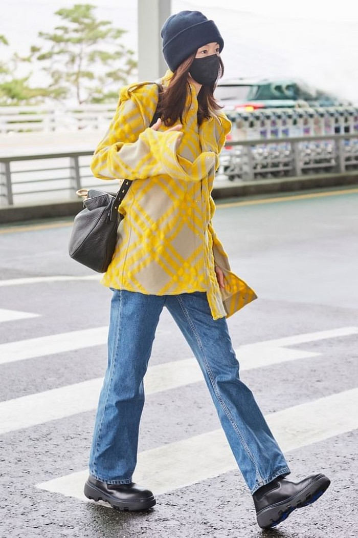 Jun Ji Hyun tampil sederhana namun stunning di Bandara Incheon dengan check shirt warna kuning, celana jeans, serta perpaduan sepatu boots dan beannie warna senada./ Foto: femalemag.com