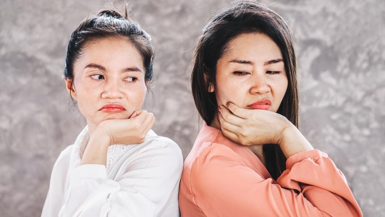 two Asian females enemy workers jealous each other at workplace
