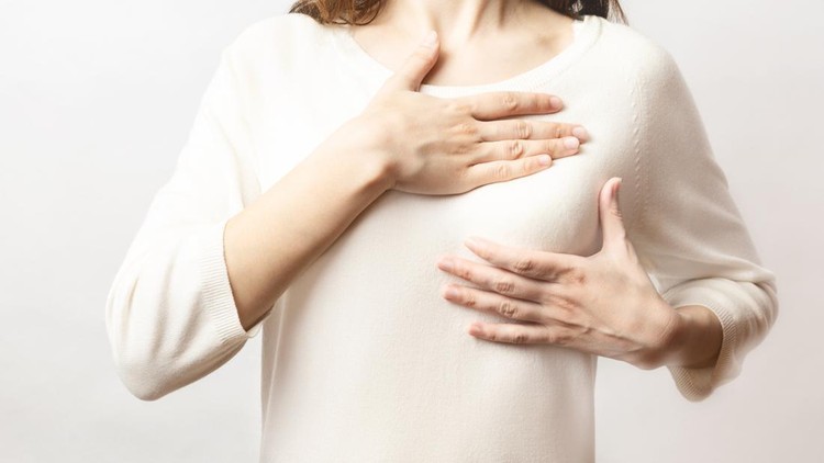 Ilustrasi payudara Woman hand checking lumps on her breast for signs of breast cancer on white background. Healthcare concept. Cancer self check; healthy girl.