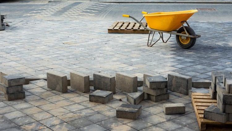 Brand new street in Utrecht with  yellow wheelbarrow Building site sand  and bricks still on the ground