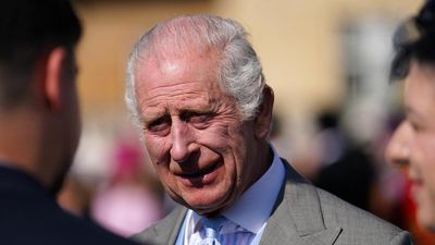 Britain's King Charles III speaks to guests as he hosts a Royal Garden Party at Buckingham Palace in central London, on May 8, 2024. (Photo by Jordan Pettitt / POOL / AFP)