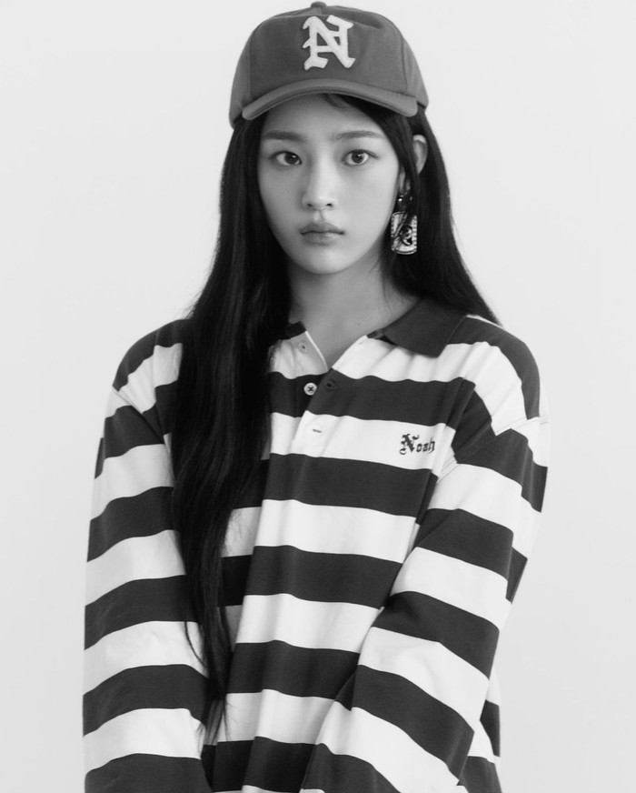 NewJeans tidak pernah ketinggalan untuk tampil ala retro. Minji dengan manis mengenakan kaus rugby garis-garis dan menambahkan topi sebagai item yang menonjolkan fashion ala 90-an. / Foto: Elle Korea