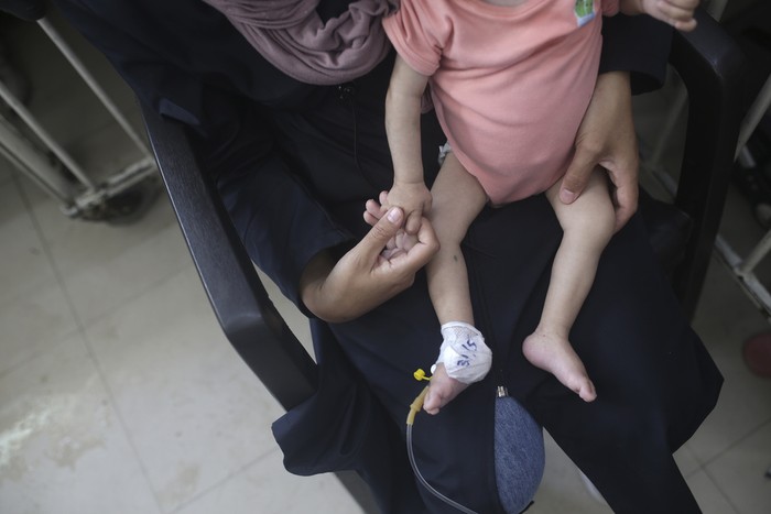 Amira Al-Jojo, left, stands beside her 10-month-old son, Yousef Al-Jojo, who suffers from malnutrition at Al-Aqsa Martyrs Hospital, where he is undergoing treatment, in Deir al-Balah in the central Gaza Strip on Saturday, June 1, 2024. At right is Nuha Al-Khaldi and her child. (AP Photo/ Jehad Alshrafi)