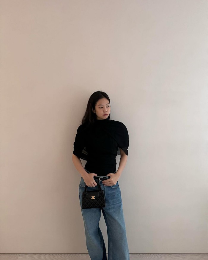 Salah satu item yang sering muncul dalam fashion kasual Jennie adalah celana denim dengan siluet longgar yang mempertegas pinggang rampingnya. Ia juga menampakkan pesona outfit-nya dengan atasan bernuansa elegan./ Foto: Elle Korea