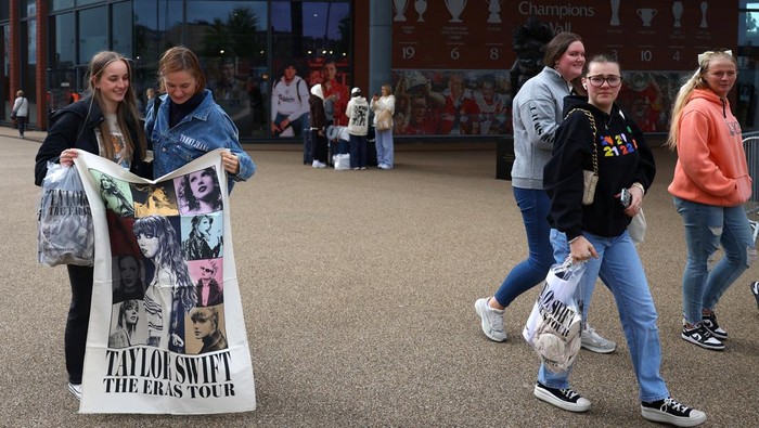 People leave the club shop at Anfield Stadium after an early merchandise release for Taylor Swift fans, in Liverpool, Britain June 12, 2024. REUTERS/Molly Darlington