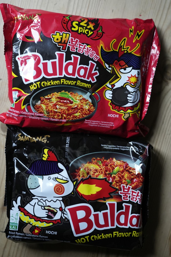 In this photo illustration two packets of Samyang noodles are pictured in London, Wednesday, June 12, 2024. Food authorities in Denmark have recalled three types of spicy instant noodle products imported from South Korea over possible risks for “acute poisoning.”  (AP Photo)