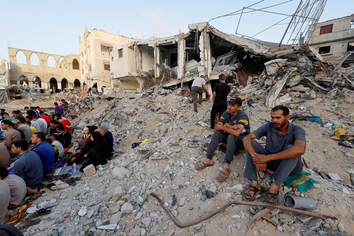 Palestinians hold Eid al-Adha prayers by the ruins of the Al-Rahma mosque destroyed by Israeli air strikes, amid the Israel-Hamas conflict, in Khan Younis, in the southern Gaza Strip, June 16, 2024. REUTERS/Mohammed Salem