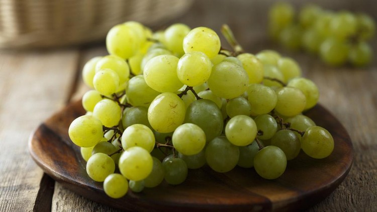 Ripe white grape on wooden desk