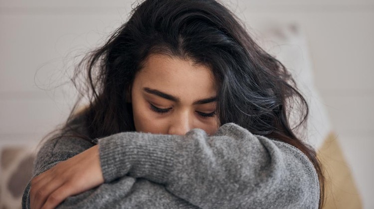 Woman, stress and depression in lonely mental health problems, issues or anxiety at home. Sad female face suffering from loneliness, withdrawal or abuse with depressed emotion alone in the bedroom