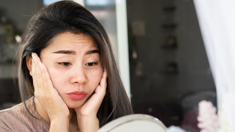 Asian woman having problem with eyes bags , dark circles, wrinkle and crow's feet on her face skin