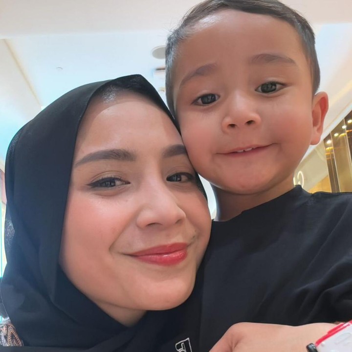<p>Gigi kembali memperlihatkan dirinya yang mengenakan hijab warna hitam ketika ia berpose dengan si bungsu Rayyanza. (Foto: Instagram @raffinagita1717)</p>