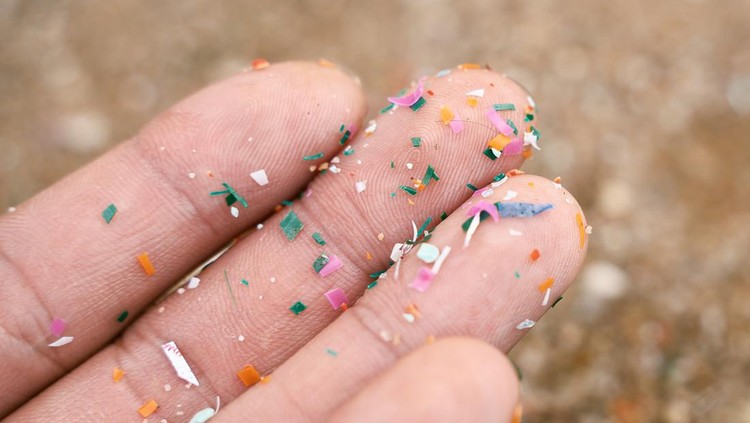 Close up side shot of microplastics lay on people hand. Concept of water pollution and global warming. Climate change idea. micro plastics concept in food and water or sea