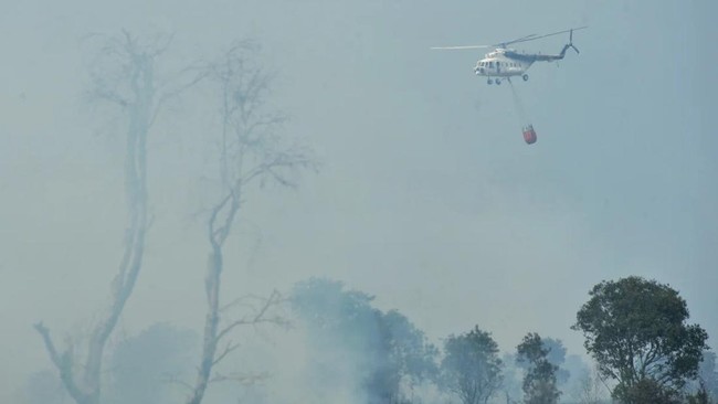 Helikopter Badan Nasional Penanggulangan Bencana (BNPB) melepaskan 'water bombing' untuk memadamkan api yang membakar lahan gambut di Jalan Palem Raya KM 27 Indralaya Kabupaten Ogan Ilir (OI), Sumatera Selatan, Sabtu (1/8). Titik api di kawasan Sumse
