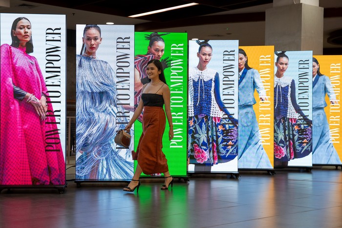 JAKARTA, INDONESIA - JULY 24: An Indonesian girl walks pass through JF3 signboards during the JF3 Jakarta Fashion Festival at MKG Empower Hall Summarecon Mall Kelapa Gading on July 24, 2023 in Jakarta, Indonesia. (Photo by Robertus Pudyanto/Getty Images)