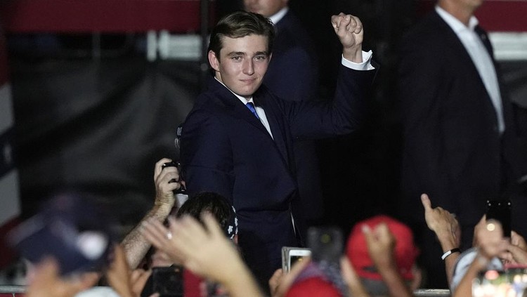 Barron Trump gestures after his father Republican presidential candidate former President Donald Trump introduced him during a campaign rally at Trump National Doral Miami, Tuesday, July 9, 2024, in Doral, Fla. (AP Photo/Marta Lavandier)