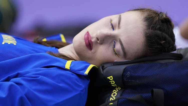 Yaroslava Mahuchikh, of Ukraine, rests before starting in the women's high jump qualification at the 2024 Summer Olympics, Friday, Aug. 2, 2024, in Saint-Denis, France. (AP Photo/Bernat Armangue)