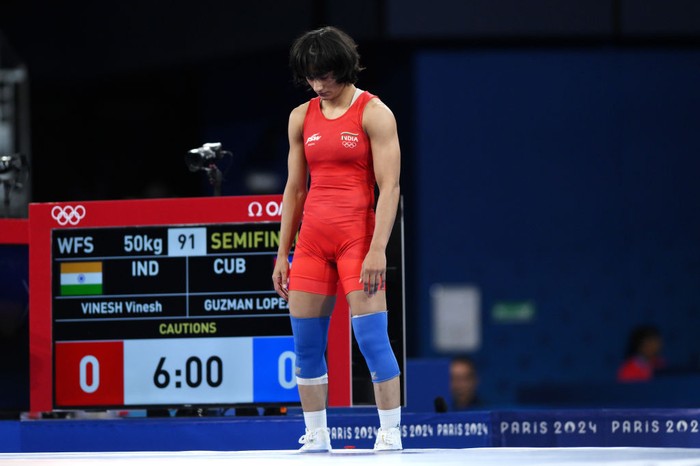 PARIS, FRANCE - AUGUST 06: Vinesh Vinesh of Team India (red) looks on as competes with Yusneylis Guzman Lopez of Team Cuba (not pictured) during the Wrestling Women's Freestyle 50kg Semifinal on day eleven of the Olympic Games Paris 2024 at Champs-de-Mars Arena on August 06, 2024 in Paris, France. (Photo by David Ramos/Getty Images)