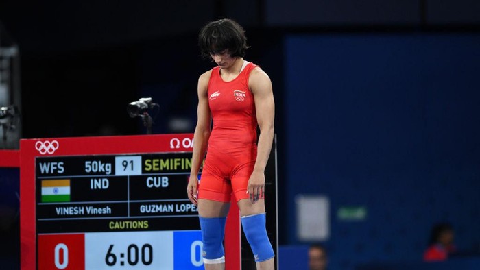 PARIS, FRANCE - AUGUST 06: Vinesh Vinesh of Team India (red) looks on as competes with Yusneylis Guzman Lopez of Team Cuba (not pictured) during the Wrestling Women's Freestyle 50kg Semifinal on day eleven of the Olympic Games Paris 2024 at Champs-de-Mars Arena on August 06, 2024 in Paris, France. (Photo by David Ramos/Getty Images)