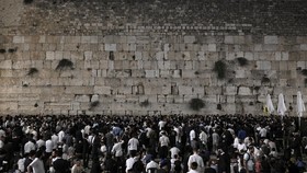 Orthodox Jewish men pray at the Western Wall in Jerusalem's Old City on August 12, 2024, during the annual Tisha B'Av (Ninth of Av) fasting and memorial day, commemorating the destruction of ancient Jewish temples some 2000 years ago. Commemorated un