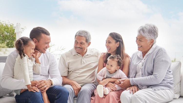 Happy family with children and grandparents talking, communication and conversation on couch outdoor in family home. Big family of elderly retirement people, love young couple and kids smile together