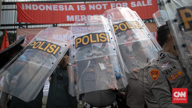 Aparat terlibat dorong-dorongan dengan massa demonstran penolak RUU Pilkada di belakang kompleks Gedung DPR/MPR RI, Jakarta, Kamis (22/8).