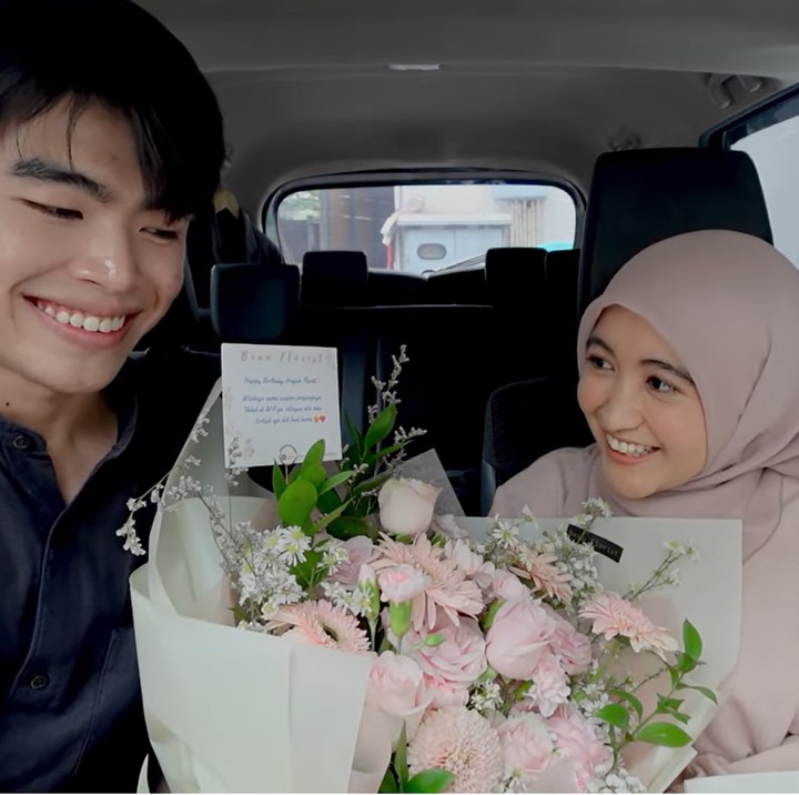 <p>Namun sebelum berangkat makan siang, Steven ternyata memberikan kejutan istimewa untuk Arafah. Ia memberinya buket bunga besar dan kue ulang tahun yang sesungguhnya. "Ternyata aku dibeliin! Kue ulang tahunnya besar, enggak nyangka.. Aku tadi sudah bete karena digituinnya pakai dorayaki," ungkap Arafah. (Foto: YouTube Arafah Rianti)</p>