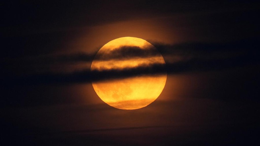 A supermoon rises behind clouds over Larnaca international airport in the eastern Mediterranean island of Cyprus&comma; on Tuesday&comma; Sept&period; 17&comma; 2024&period; &lpar;AP Photo&sol;Petros Karadjias&rpar;