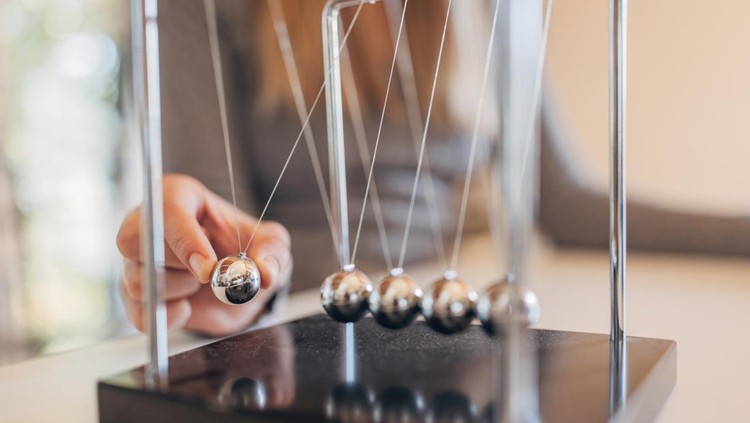 Newton's cradle businessman concept for cause and effect