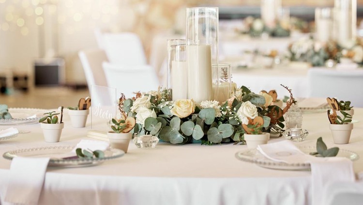 Wedding reception, table setting and celebration event with flower arrangement, decor and catering for a romantic setting. Party, luxury restaurant or fancy place with cutlery and tableware