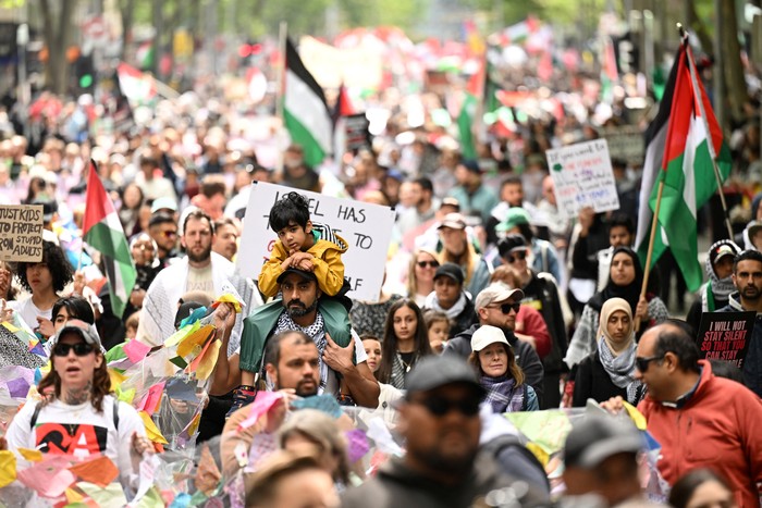 A drone view shows a giant Palestinian flag, as people march through the streets of the township of Lenasia, during the 