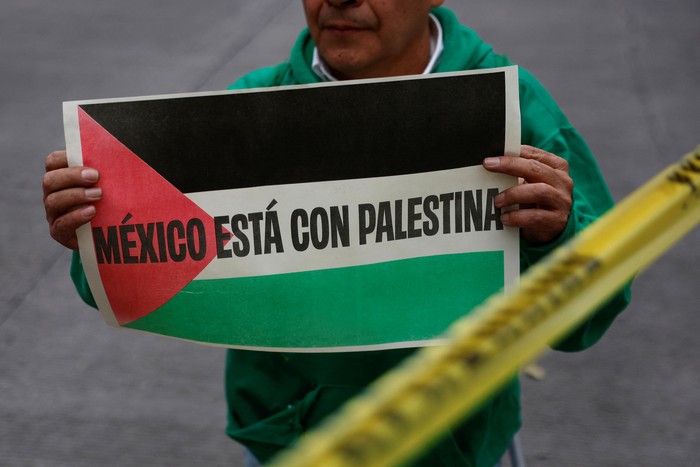 A drone view shows a giant Palestinian flag, as people march through the streets of the township of Lenasia, during the 