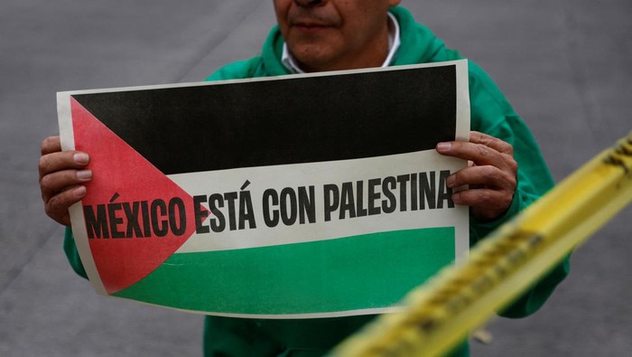A drone view shows a giant Palestinian flag, as people march through the streets of the township of Lenasia, during the 