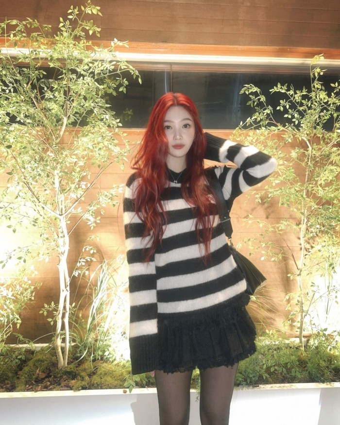 Joy menambah suasana ceria dengan memadukan sweater bermotif garis-garis hitam putih dengan rok mini ruffle. Kombinasi kedua item tersebut semakin mengungkap pesona Joy yang menyegarkan./ Foto: Elle Korea