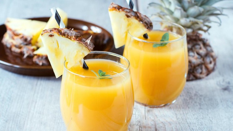 Fresh pineapple juice in the glasse,selective focus