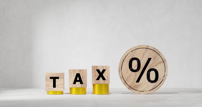 Tax concept with wooden cubes. Tax payment reminder or annual taxation concept.