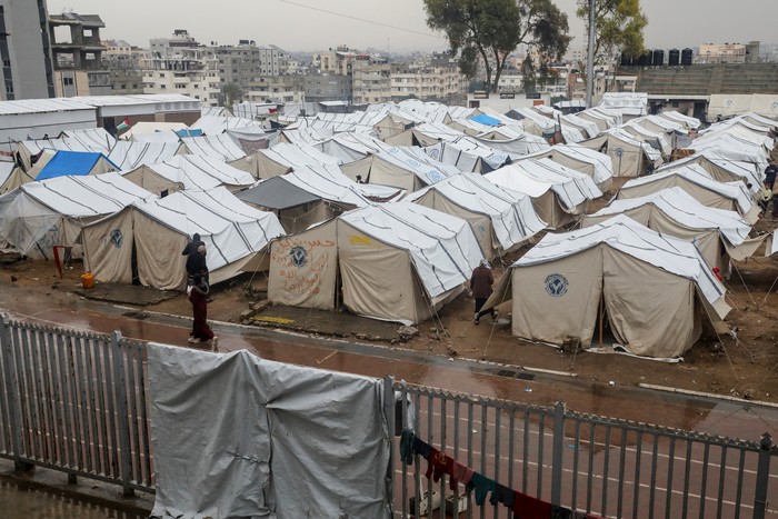 A Displaced Palestinian man stands in front of a tent following rainfall, amid the Israel-Hamas conflict, in Gaza City November 24, 2024. REUTERS/Dawoud Abu Alkas