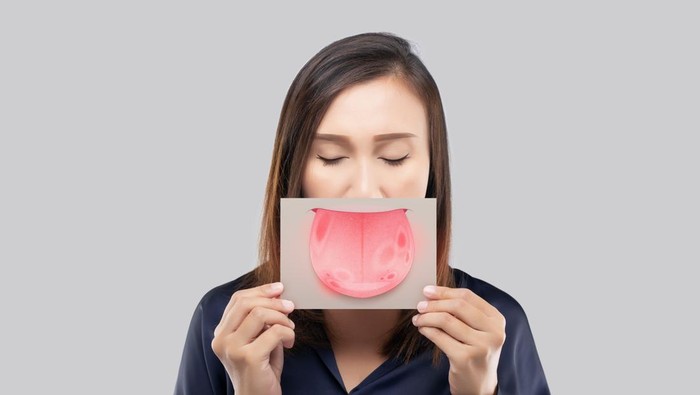 The woman show the picture of tongue problems, Illustration benign migratory glossitis on a brown paper, Behcet's Disease