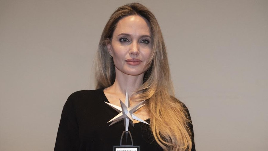 Angelina Jolie poses with the Star of the Mole award, in Turin, Italy, Sunday, Nov. 24, 2024.  (Matteo Secci/LaPresse via AP)