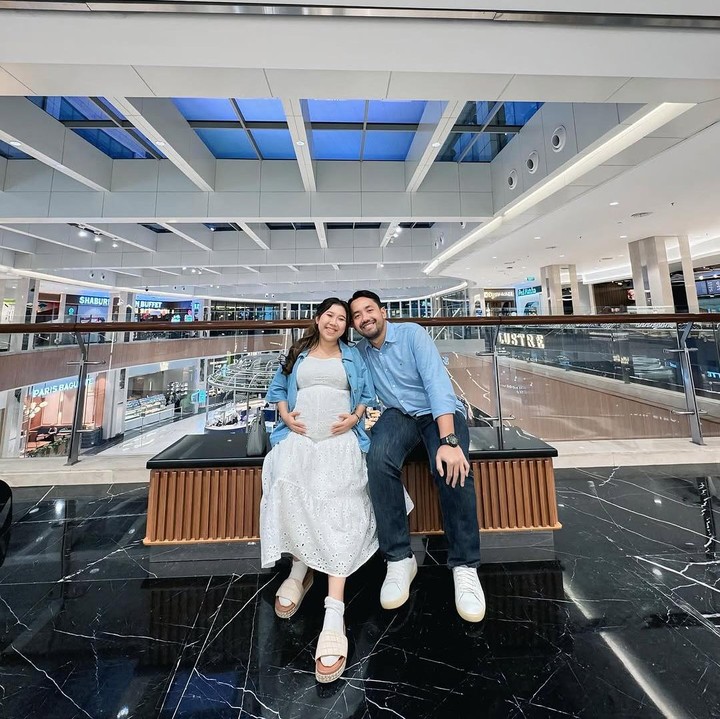 <p>Dalam foto yang diunggah, Kiky dan sang suami kompak mengenakan kemeja berwarna biru muda. Kiki tampak menyempurnakan penampilannya dengan <em>dress</em> putih, sementara sang suami mengenakan celana jeans hitam dan sepatu putih. (Foto: Instagram @ikysaputrii)</p>