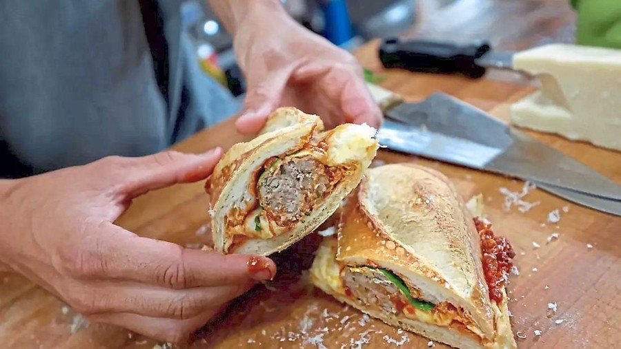 A simple tomato sauce is part of Nonna\'s meatball sandwich.